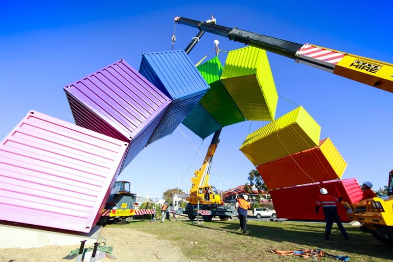 Workers using cranes during Containbow installation