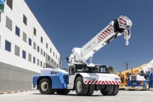 blue and white crane in front of building