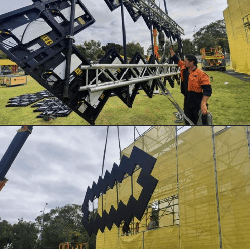 crane lifting object with person helping