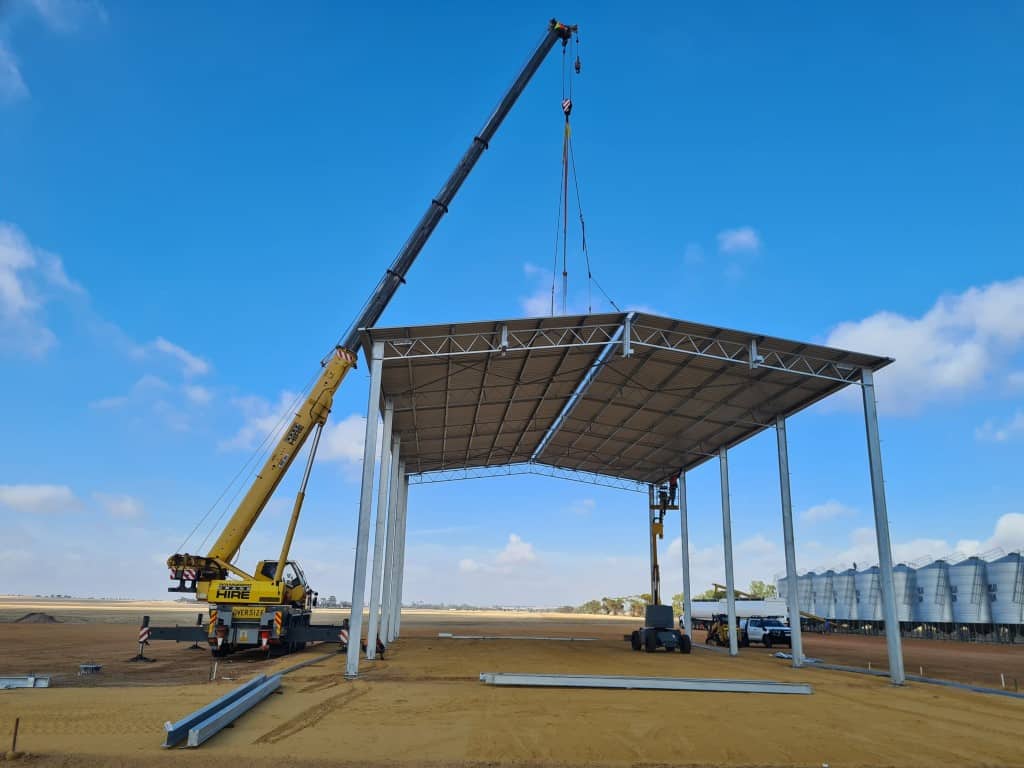 Slewing mobile crane used in construction to install a roof.